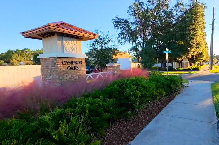 Cameron Oaks community entrance monument with ornamental grasses and trimmed shrubs